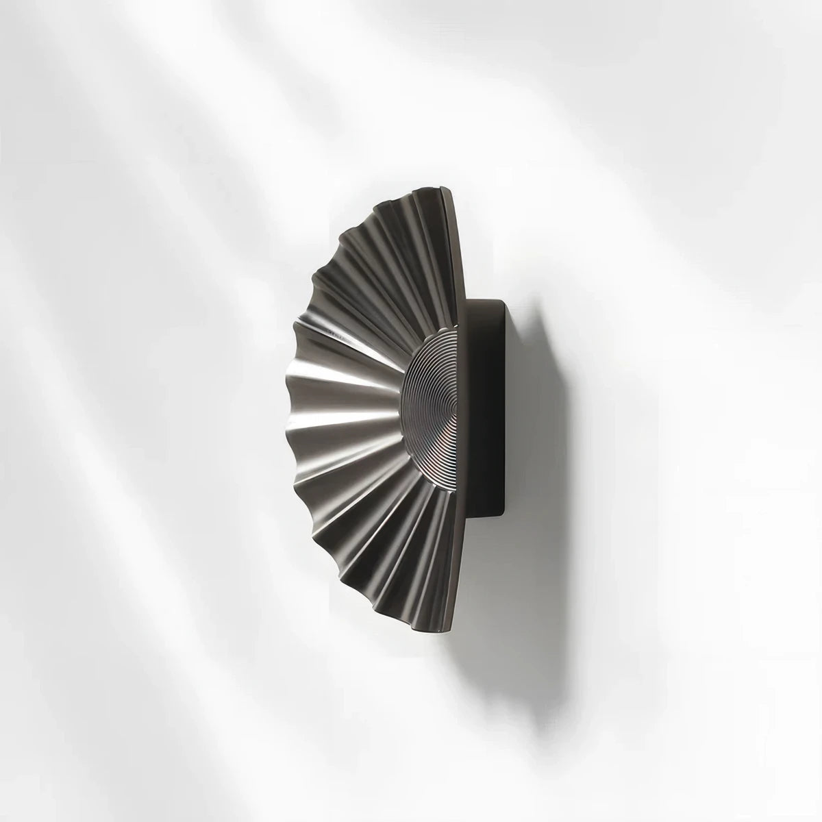 Sunburst half-moon cabinet pull and round knob, shown in a focused view with its shape and finish visible
