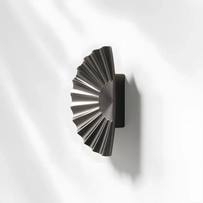 Sunburst half-moon cabinet pull and round knob, shown in a focused view with its shape and finish visible