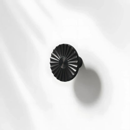 Black sunburst half-moon cabinet pull and round knob, presented for reference with the profile and mounts in view