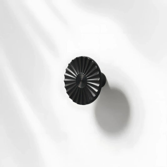 Black sunburst half-moon cabinet pull and round knob, presented for reference with the profile and mounts in view