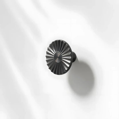 Sunburst half-moon cabinet pull and round knob, shown in a focused view with the profile and mounts in view