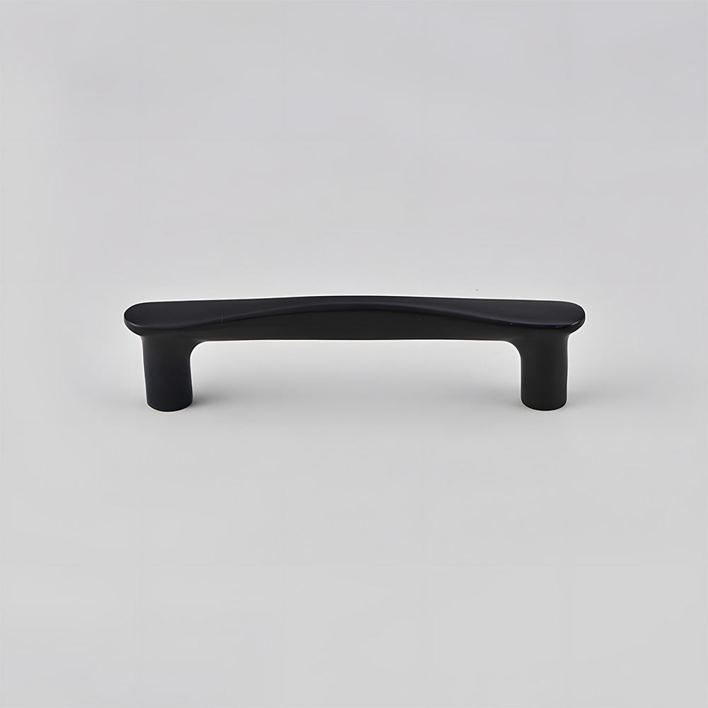 Black tapered arched brass cabinet pull, shown at close range on a clean neutral background