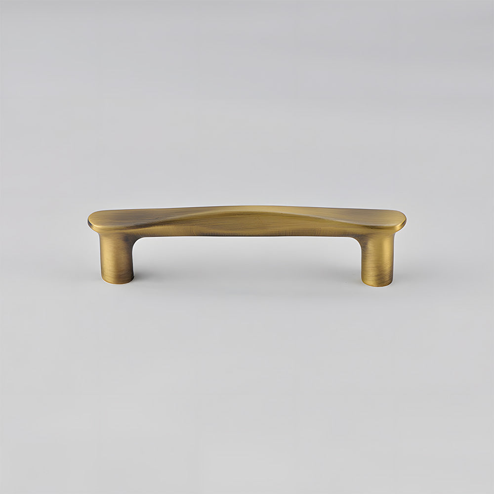 Bronze tapered arched brass cabinet pull, shown in a focused view on a clean neutral background