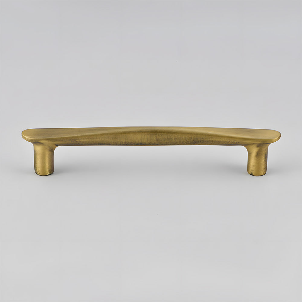 Bronze tapered arched brass cabinet pull, presented in another view on a clean neutral background