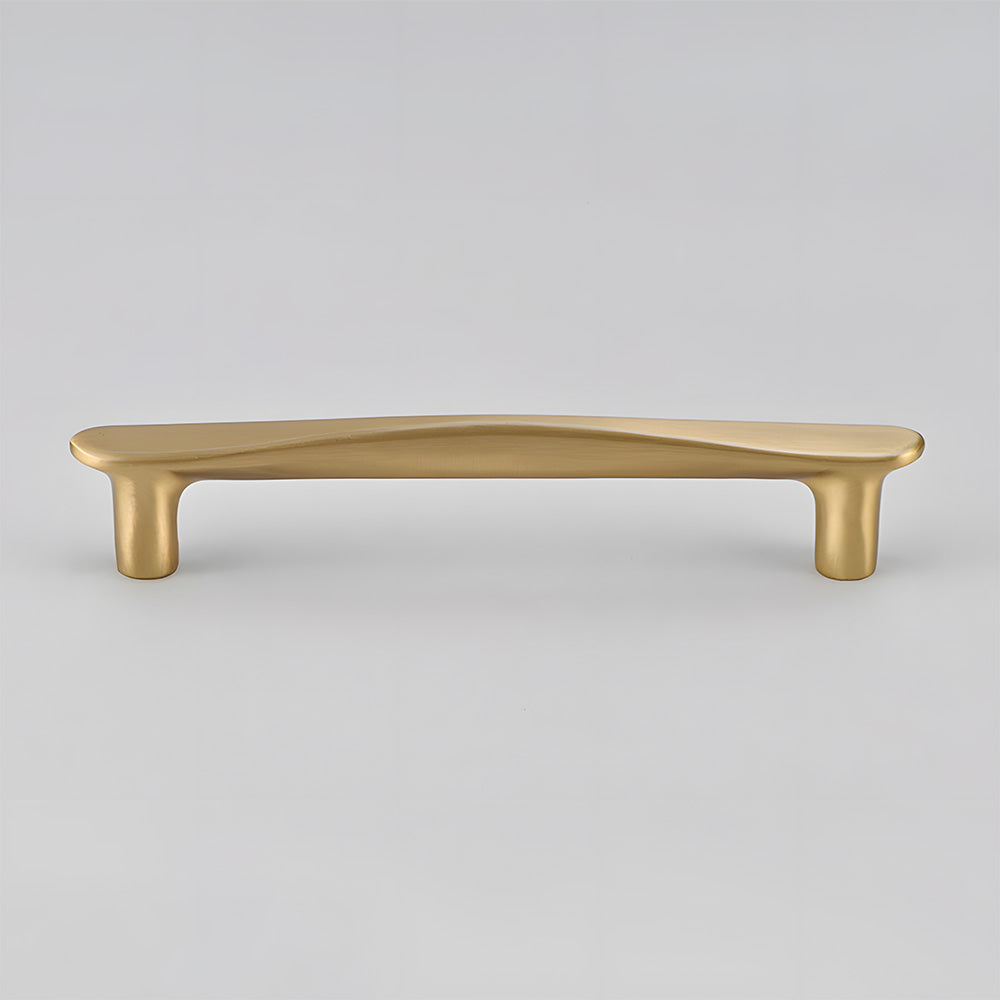 Tapered arched brass cabinet pull, pictured in one view on a clean neutral background