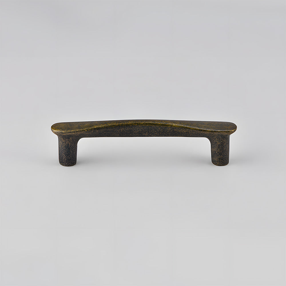 Tapered arched brass cabinet pull, presented for reference on a clean neutral background