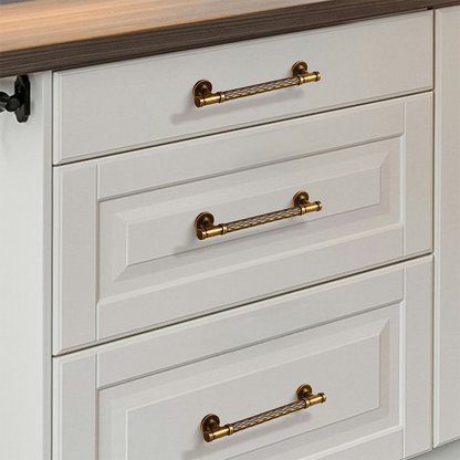 Textured round bar cabinet pull and knob, displayed from the side installed on cabinetry in context