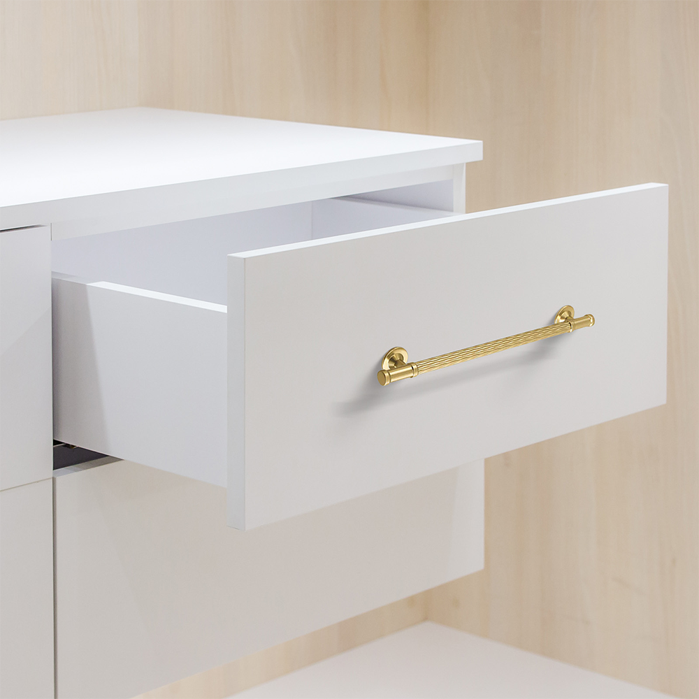 Textured round bar cabinet pull and knob, shown in a focused view installed on cabinetry in context