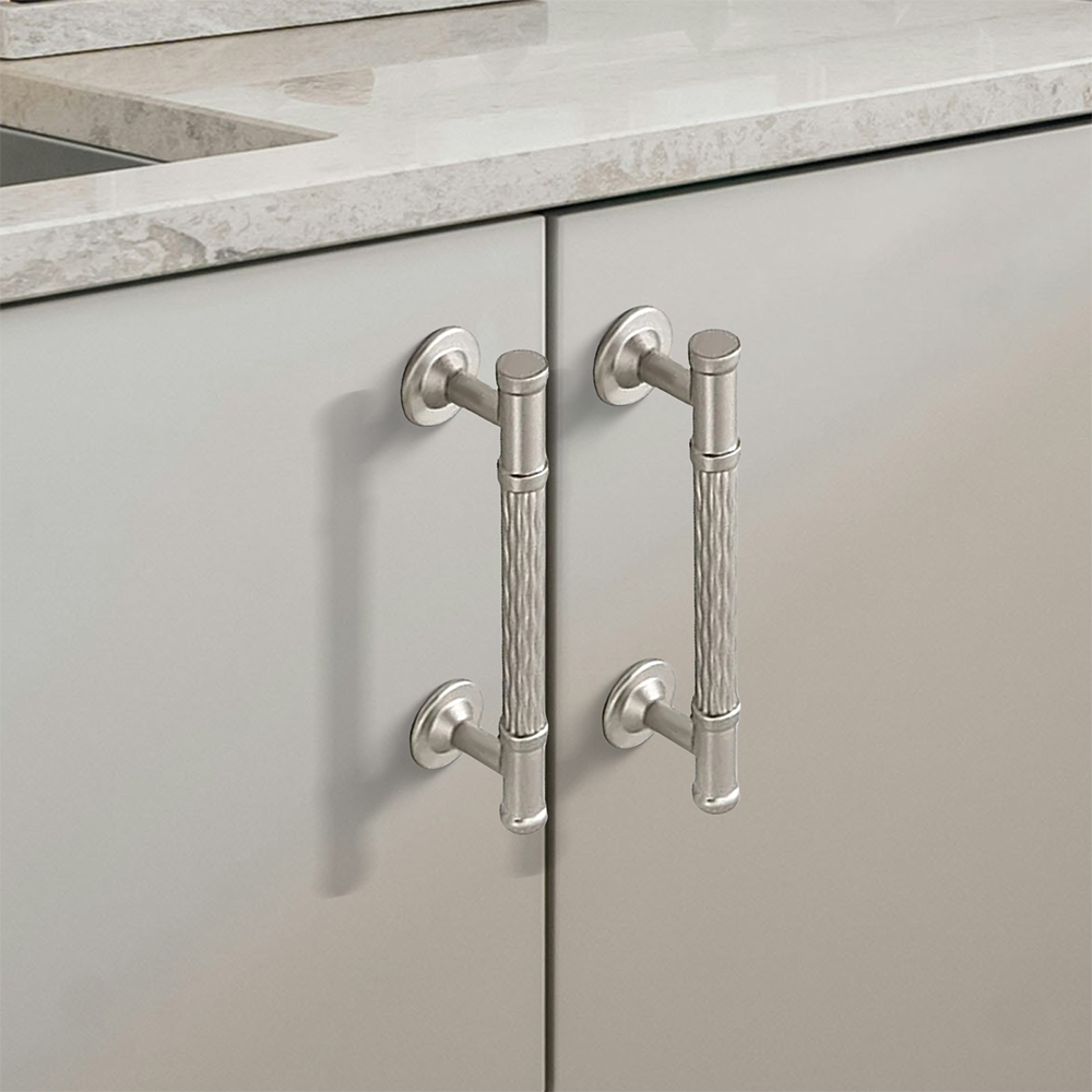 Textured round bar cabinet pull and knob, shown at close range in an installed cabinet close-up