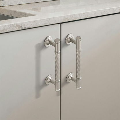 Textured round bar cabinet pull and knob, shown at close range in an installed cabinet close-up