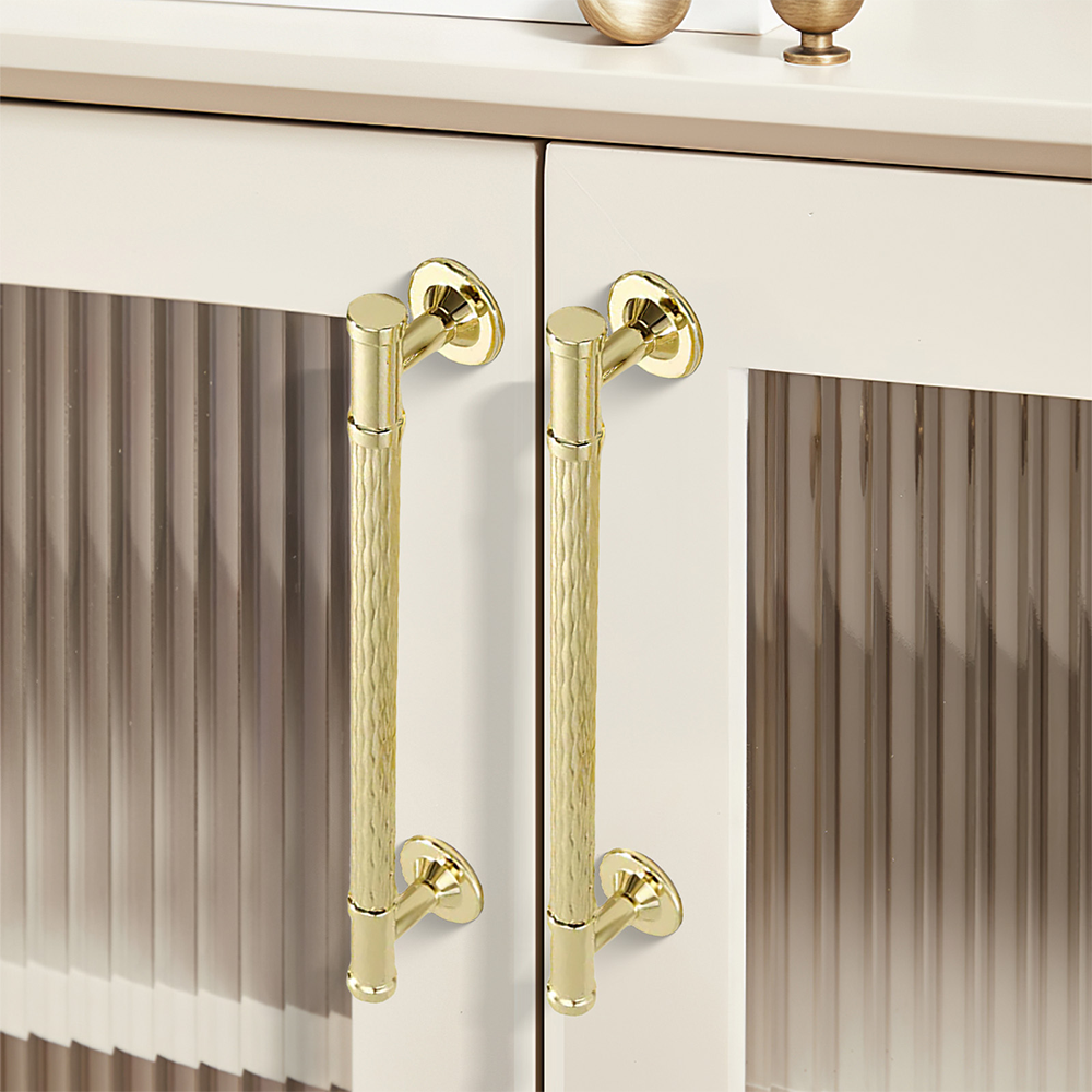 Textured round bar cabinet pull and knob, displayed from the side in an installed cabinet close-up