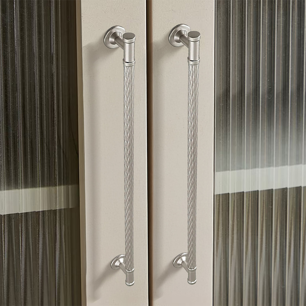Textured round bar cabinet pull and knob, shown in a focused view in an installed cabinet close-up