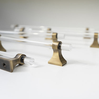 Transparent acrylic bar pull with flared metal mounts, presented for reference with its construction and finish visible