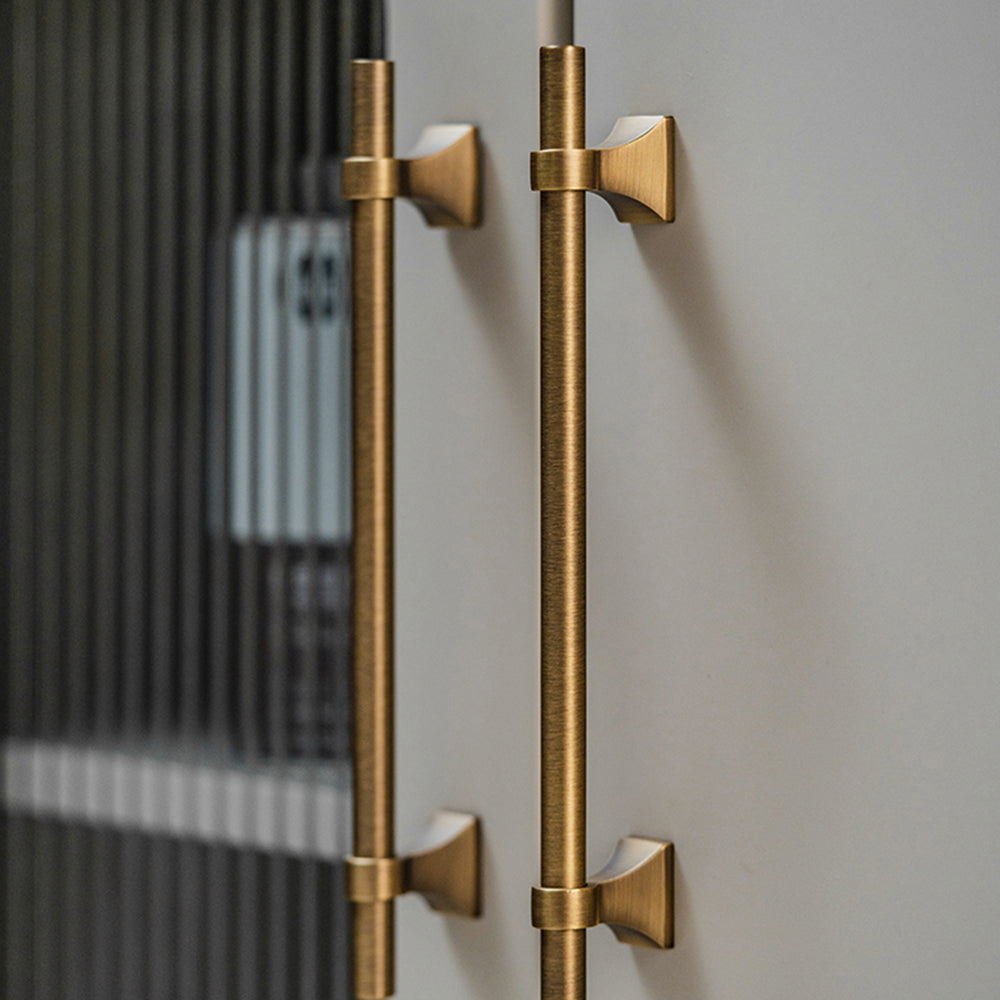 Vintage round bar cabinet pull with pedestal mounts, shown clearly in an installed cabinet close-up
