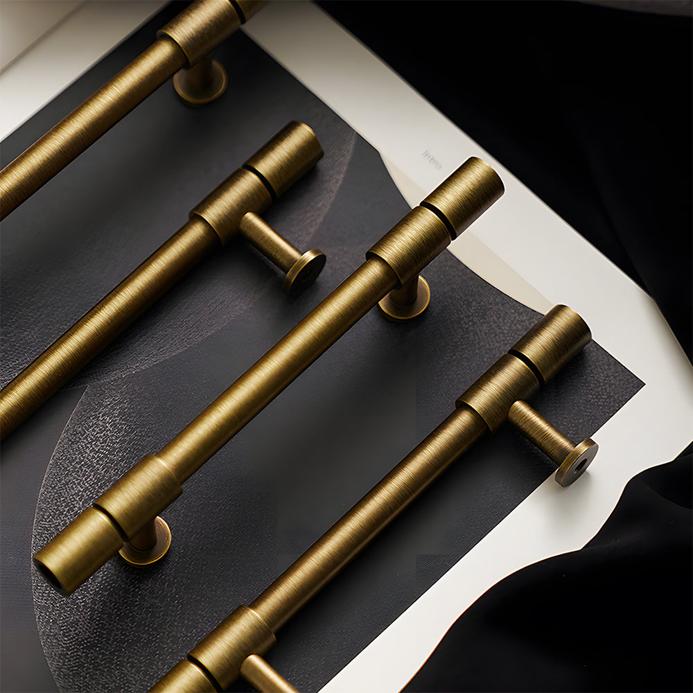 Vintage bronze brass T-bar cabinet pull, shown clearly with related hardware in one display