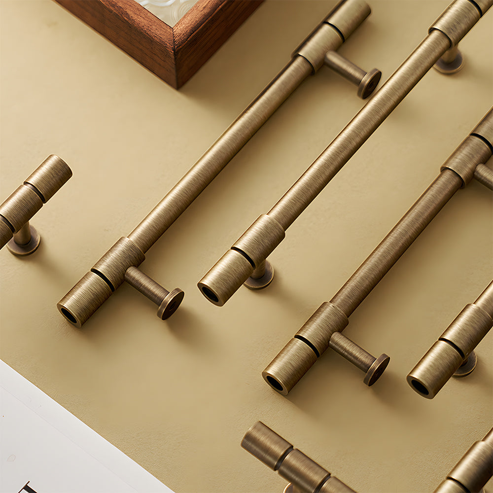 Vintage bronze brass T-bar cabinet pull, shown from one angle with related hardware in one display