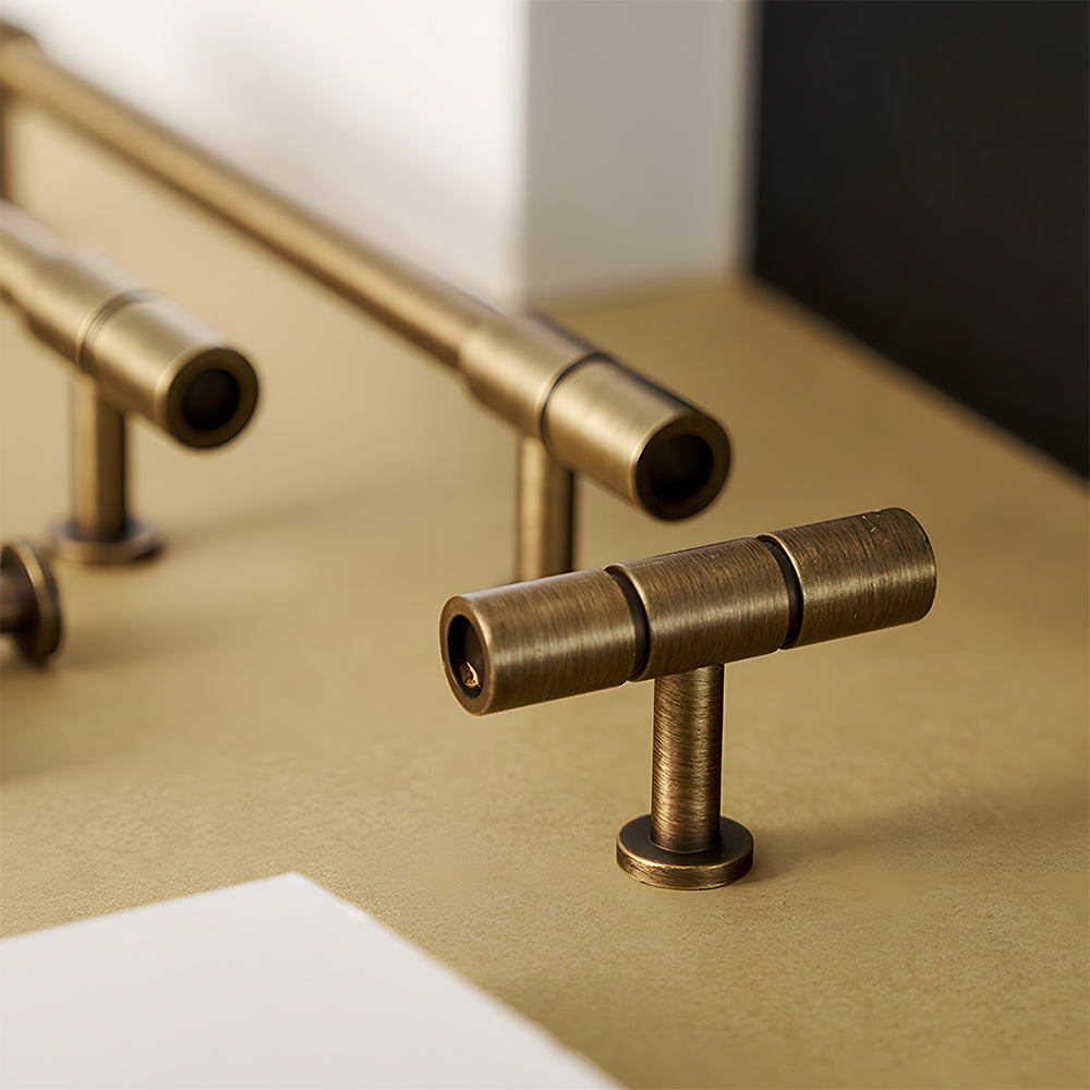 Vintage bronze brass T-bar cabinet pull, pictured in one view in an installed cabinet close-up