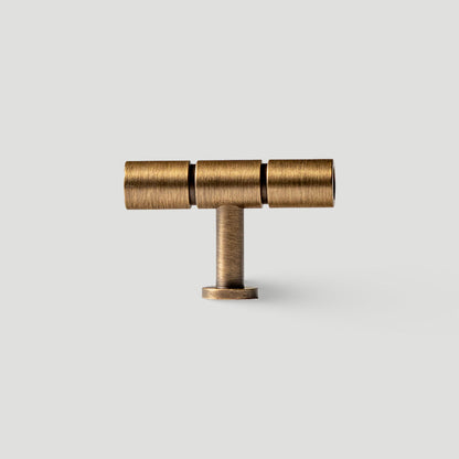 Vintage bronze brass T-bar cabinet pull, shown from one angle on a clean neutral background
