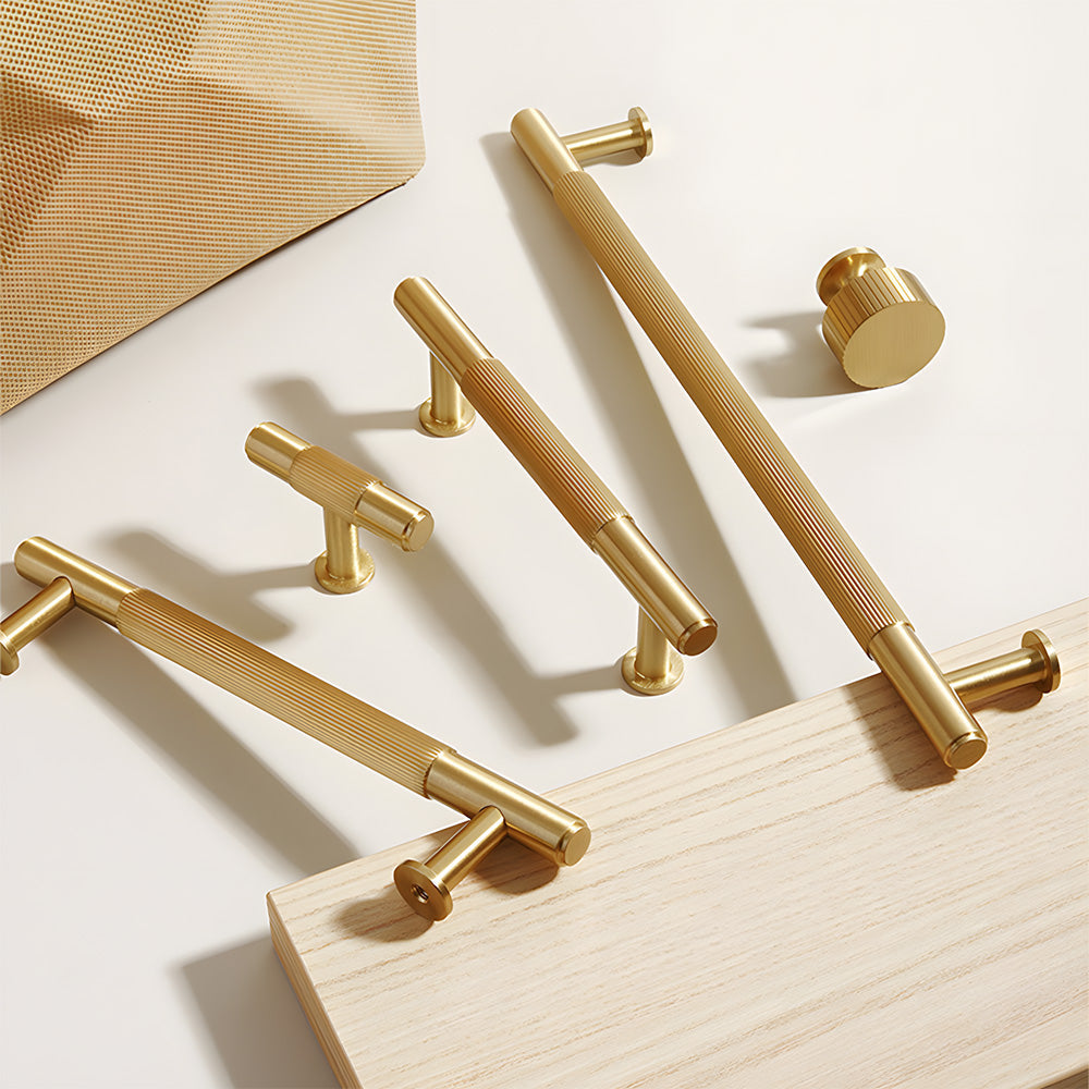 Lined aged-bronze brass T-bar cabinet pull and knob, pictured in one view as a color and finish lineup