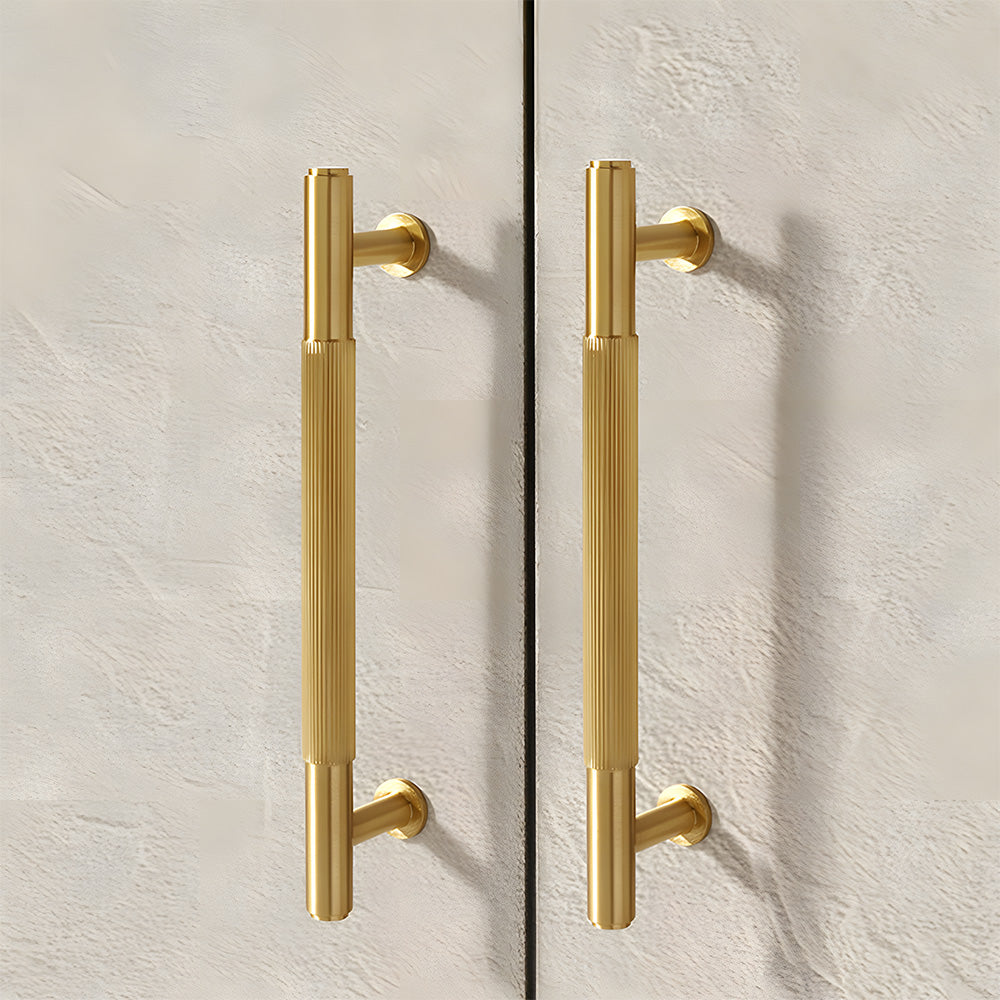Lined aged-bronze brass T-bar cabinet pull and knob, shown in a focused view in an installed cabinet close-up