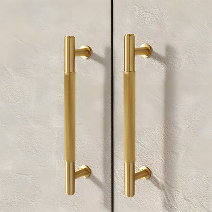 Lined aged-bronze brass T-bar cabinet pull and knob, shown in a focused view in an installed cabinet close-up