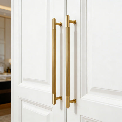 Lined aged-bronze brass T-bar cabinet pull and knob, presented in another view in an installed cabinet close-up