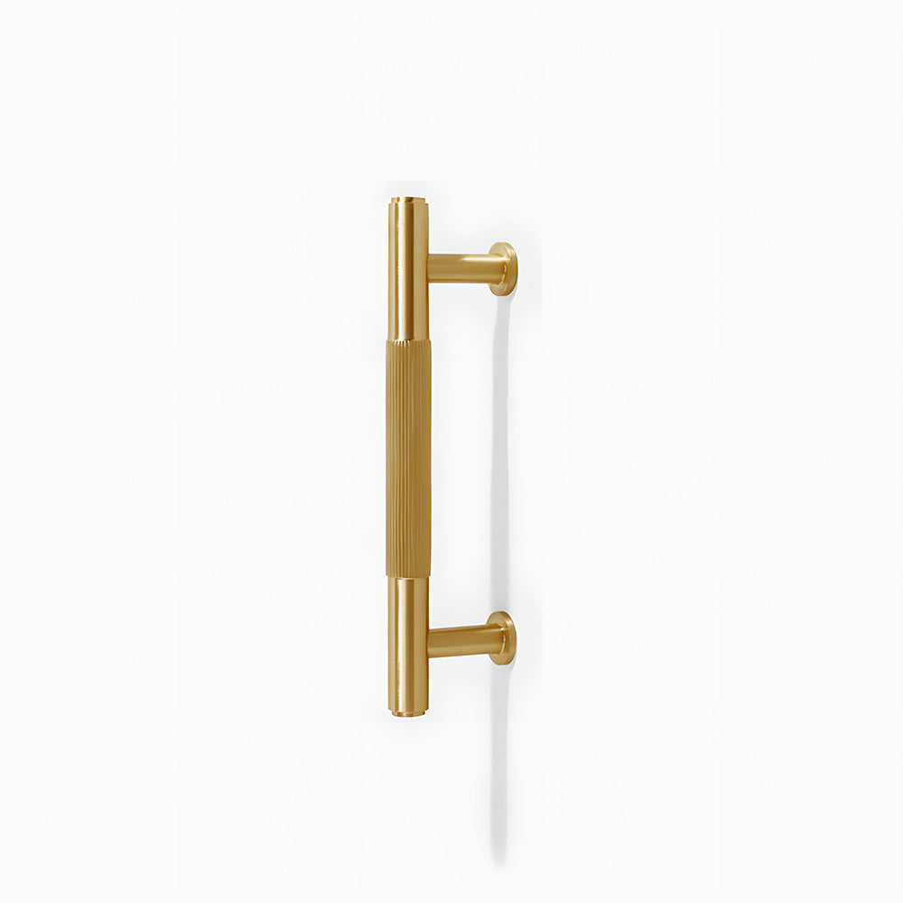 Lined aged-bronze brass T-bar cabinet pull and knob, shown at close range on a clean neutral background