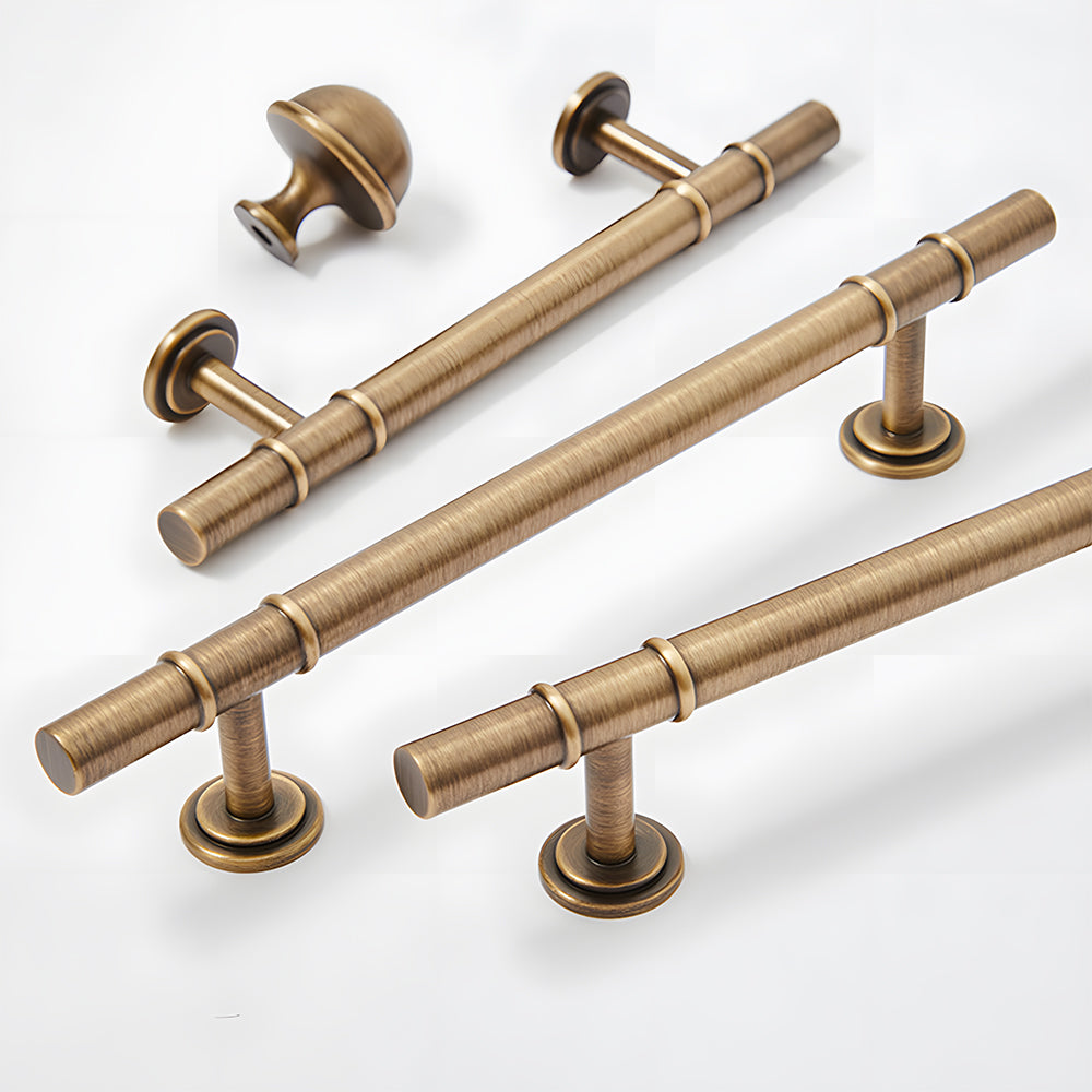Vintage brass T-bar cabinet pull and round knob, shown at close range with related hardware in one display