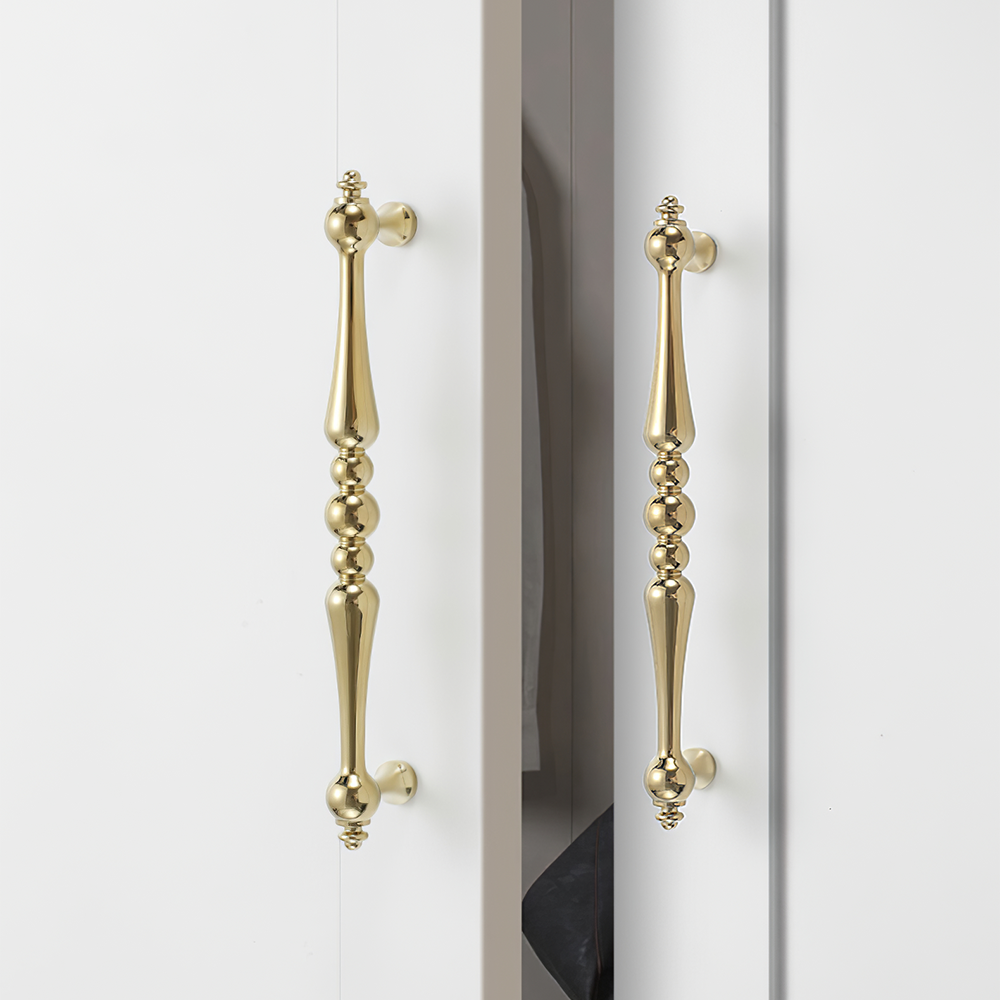 Vintage turned brass cabinet pull and round knob, presented for reference installed on cabinetry in context