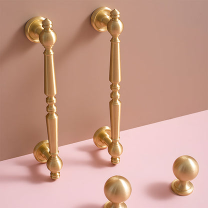 Vintage turned brass cabinet pull and round knob, displayed from the side installed on cabinetry in context