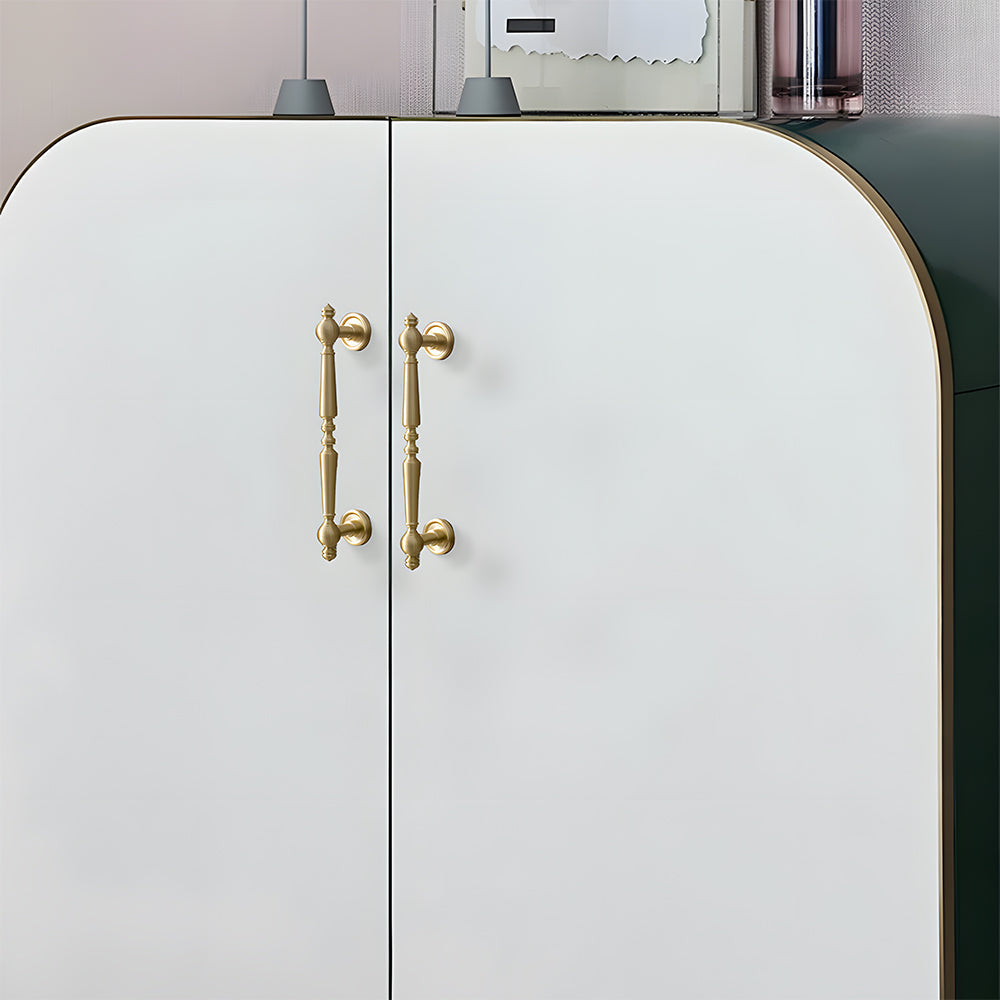 Vintage turned brass cabinet pull and round knob, shown in a focused view installed on cabinetry in context