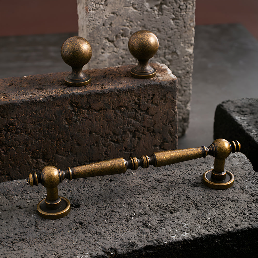Vintage turned brass cabinet pull and round knob, shown at close range as a color and finish lineup