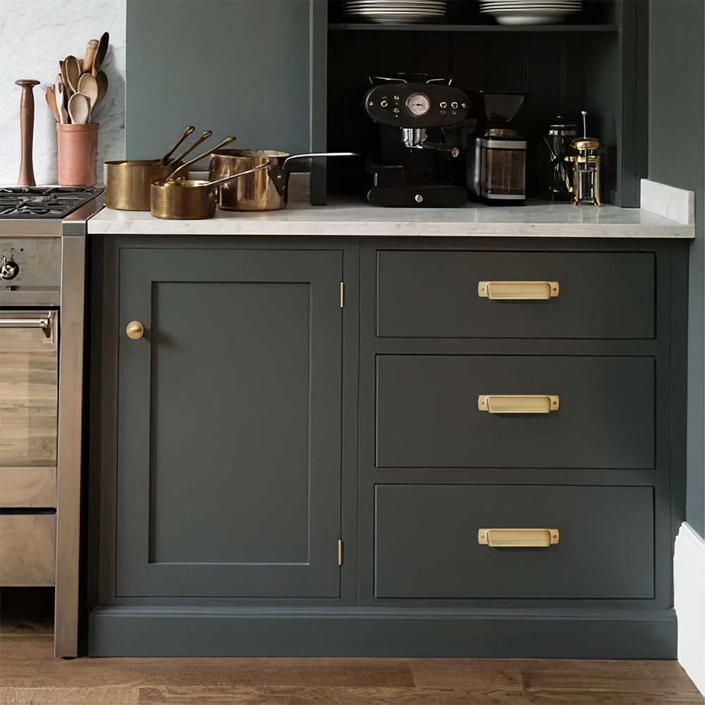 Gold vintage cup-style cabinet pull, pictured in one view installed on cabinetry in context