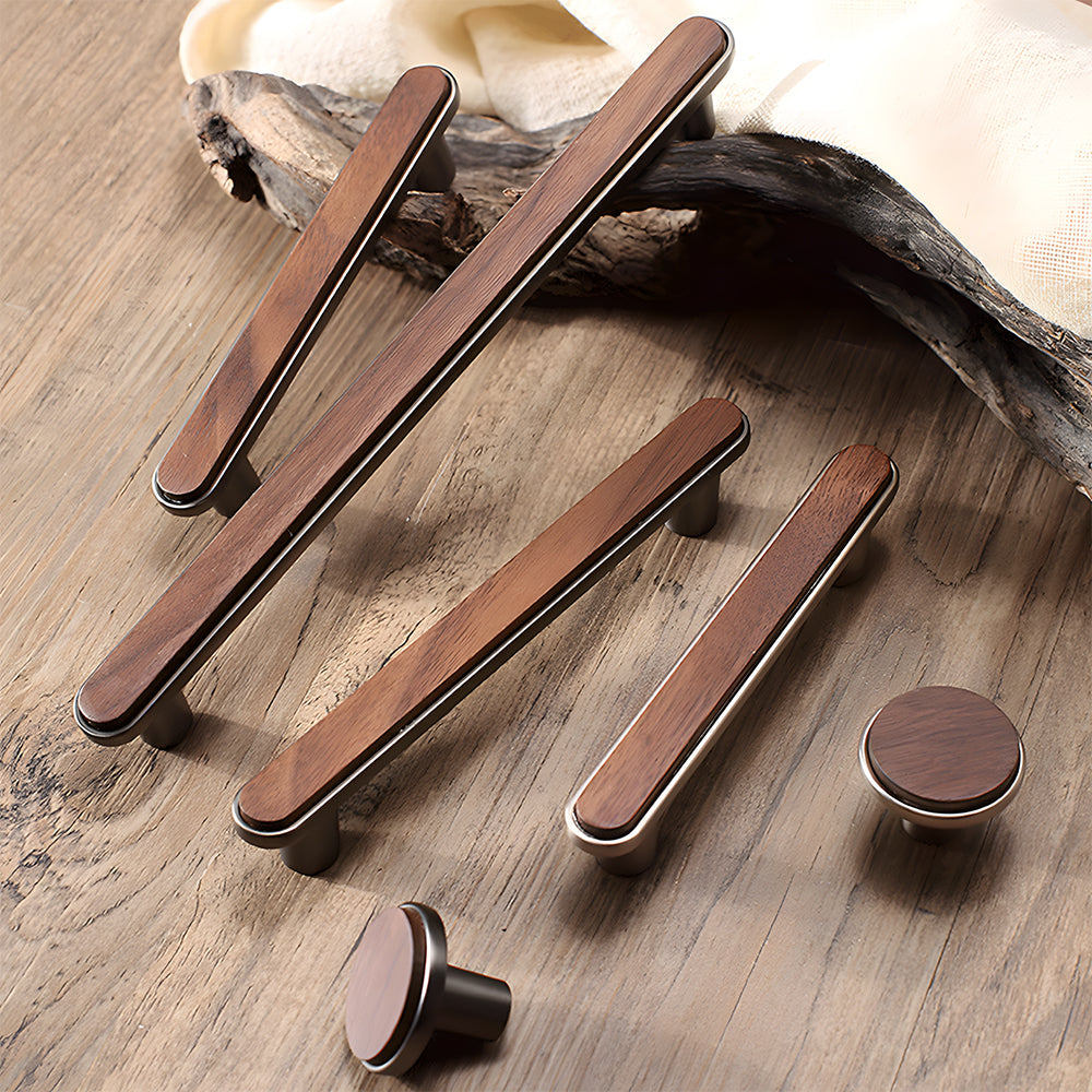Walnut wood inlay cabinet pull with a silver-toned frame, arranged together from an overhead angle for comparison