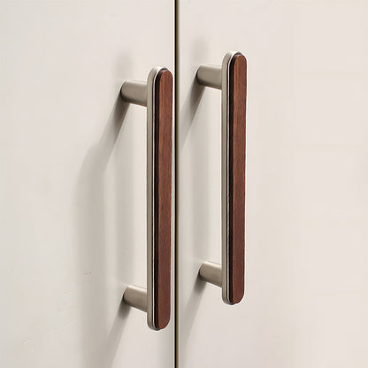 Walnut inlay cabinet pull in silver with 128 mm centers, installed on paired cabinet doors in a close view