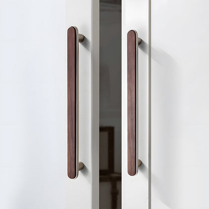 Walnut inlay cabinet pull in silver with 192 mm centers, shown on cabinet fronts in a bright room setting