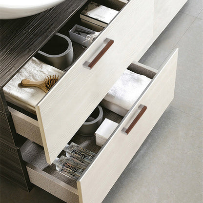 Black walnut wood T-bar cabinet pull with silver-toned ends, installed horizontally on a drawer front in a close view