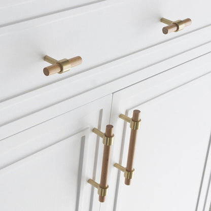 Wood cabinet pull with brass bases in beech with 224 mm centers, shown in a close installed view across cabinet fronts