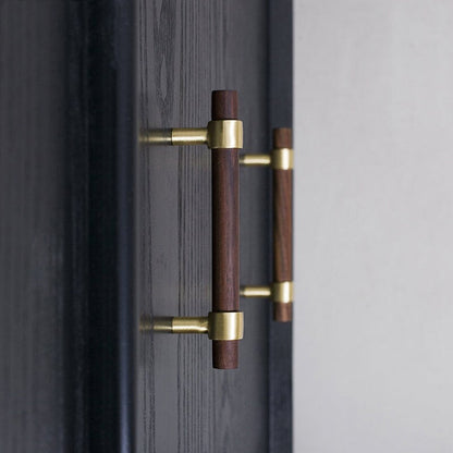 Wood cabinet pull with brass bases, mounted on tall cabinet doors in a wider room view