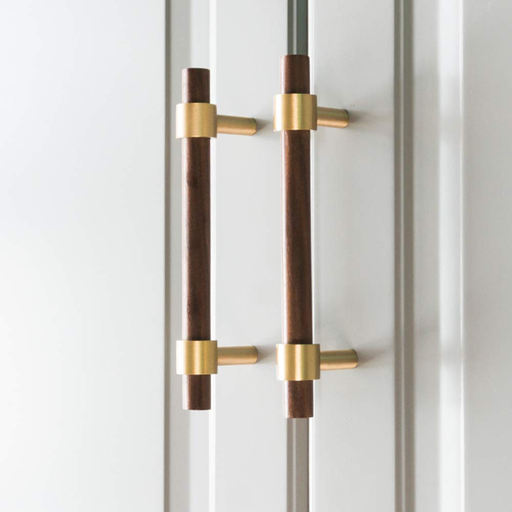 Walnut or beech wood cabinet pull with brushed brass bases, mounted as matching hardware on double cabinet doors