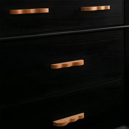 Wavy wood cabinet pull with a sculpted three-curve profile, shown across several drawer fronts in a cabinet scene