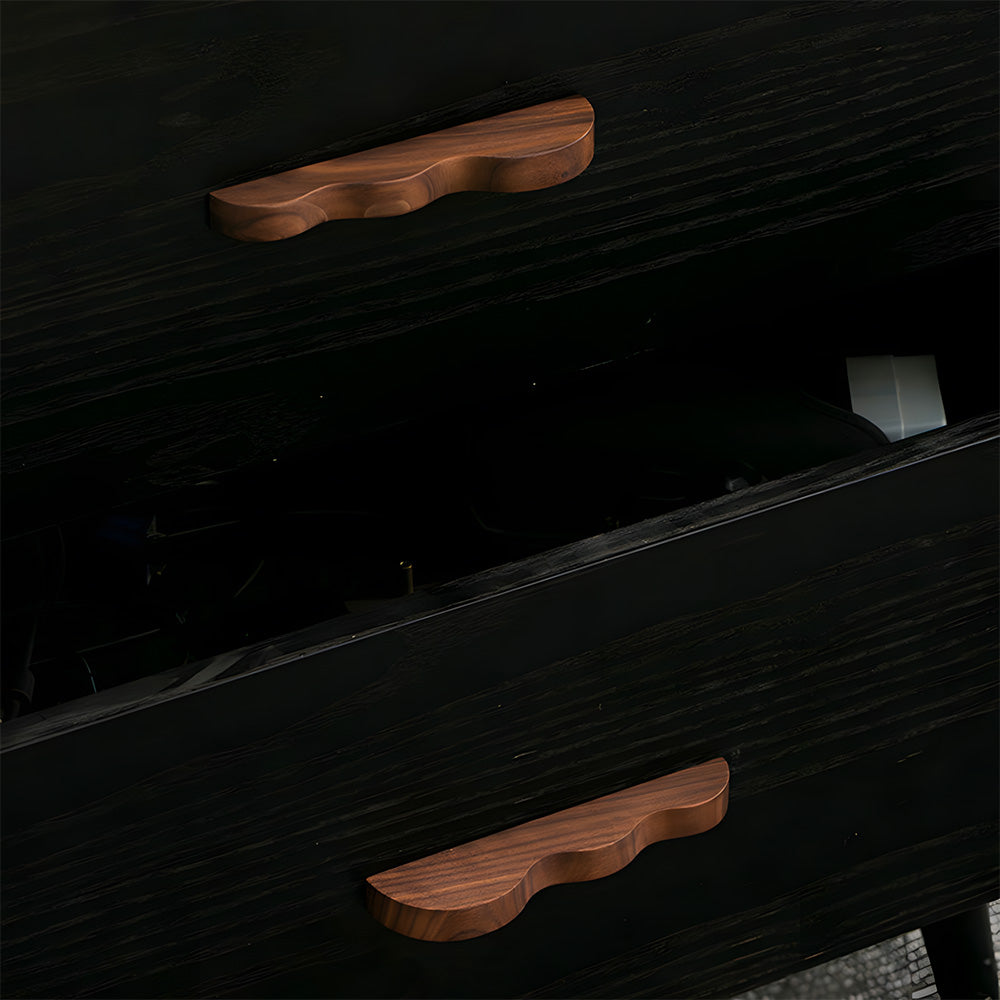 Wavy wood cabinet pull with a sculpted three-curve profile, shown in use on a pulled-open drawer