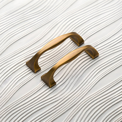 Wide arched brass cabinet pull with flared square ends, shown clearly as a color and finish lineup