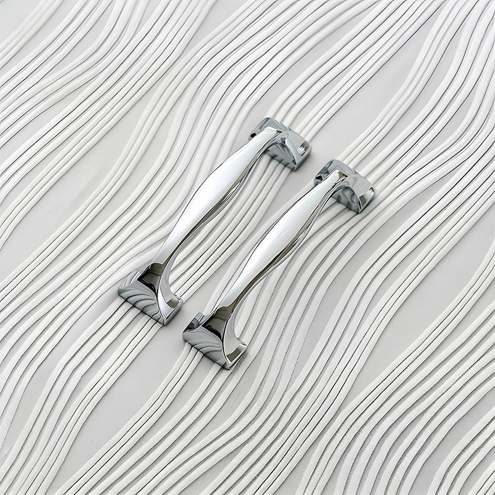 Wide arched brass cabinet pull with flared square ends, shown in a focused view as a color and finish lineup