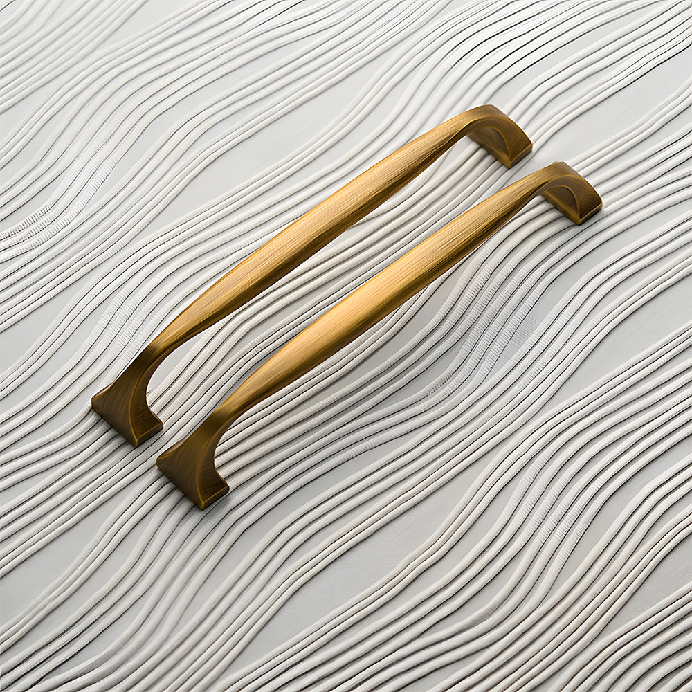 Wide arched brass cabinet pull with flared square ends, pictured in one view as a color and finish lineup