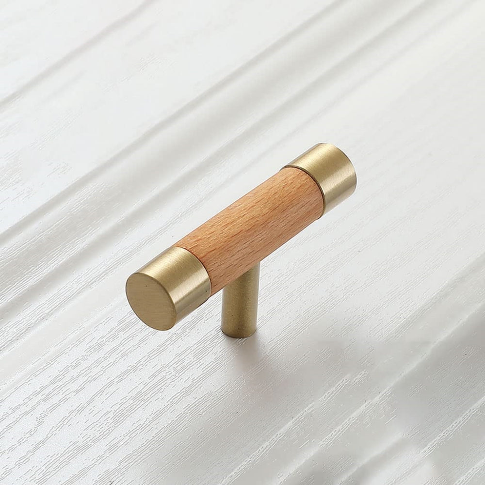 Wood cabinet handle with brass end caps, shown alone at an angle on a light background