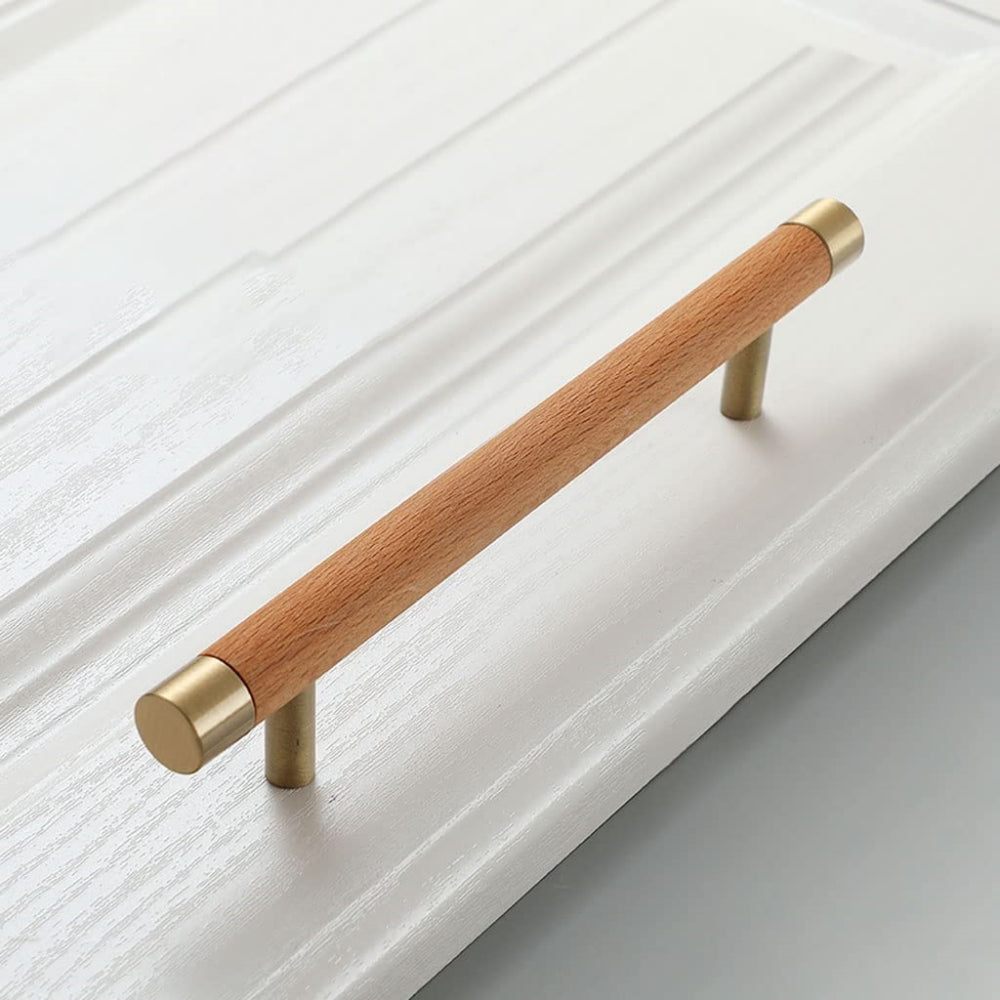 Wood cabinet handle with brass end caps, shown from a close side angle against a plain surface