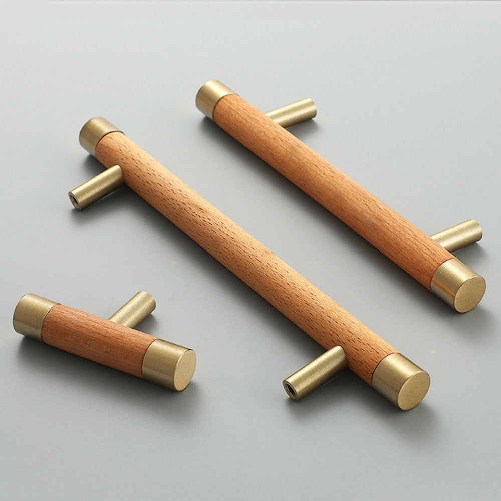 Light wood cabinet handle with brushed brass end caps, arranged together from an overhead angle for comparison