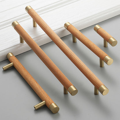 Light wood cabinet handle with brushed brass end caps, grouped in long and short versions on a neutral surface