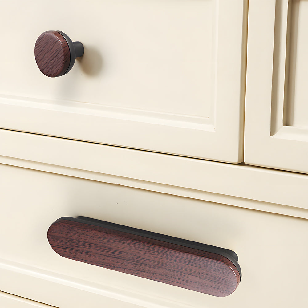 Wood-grain cabinet pull with a rounded metal base, shown across several drawer fronts in a cabinet scene